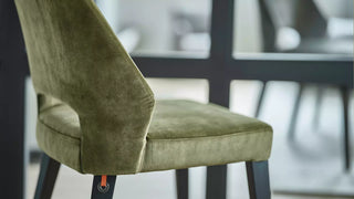 Detail of an olive green velvet Mobitec Lena chair with open back