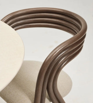 Detail of the curved rattan back of the Vincent Sheppard Arc Dining Chair at a round table