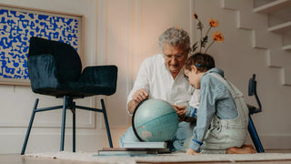 Lifestyle image of a grandfather and child with a globe next to a petrol Mobitec Mood chair