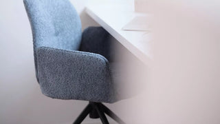 Detail of a blue-grey Mobitec Mood swivel chair at a table