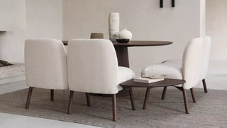 Lifestyle image of ecru Mobitec Thalia armchairs around a round dining table